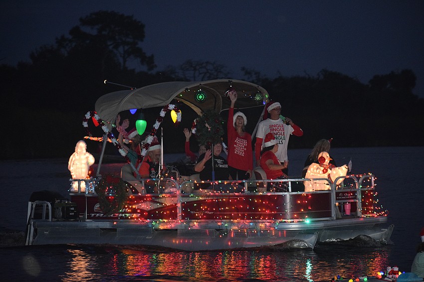The holiday spirit is beaming from a boat entry in the Jiggs Landing Holiday Boat Parade as it makes its way down the river.