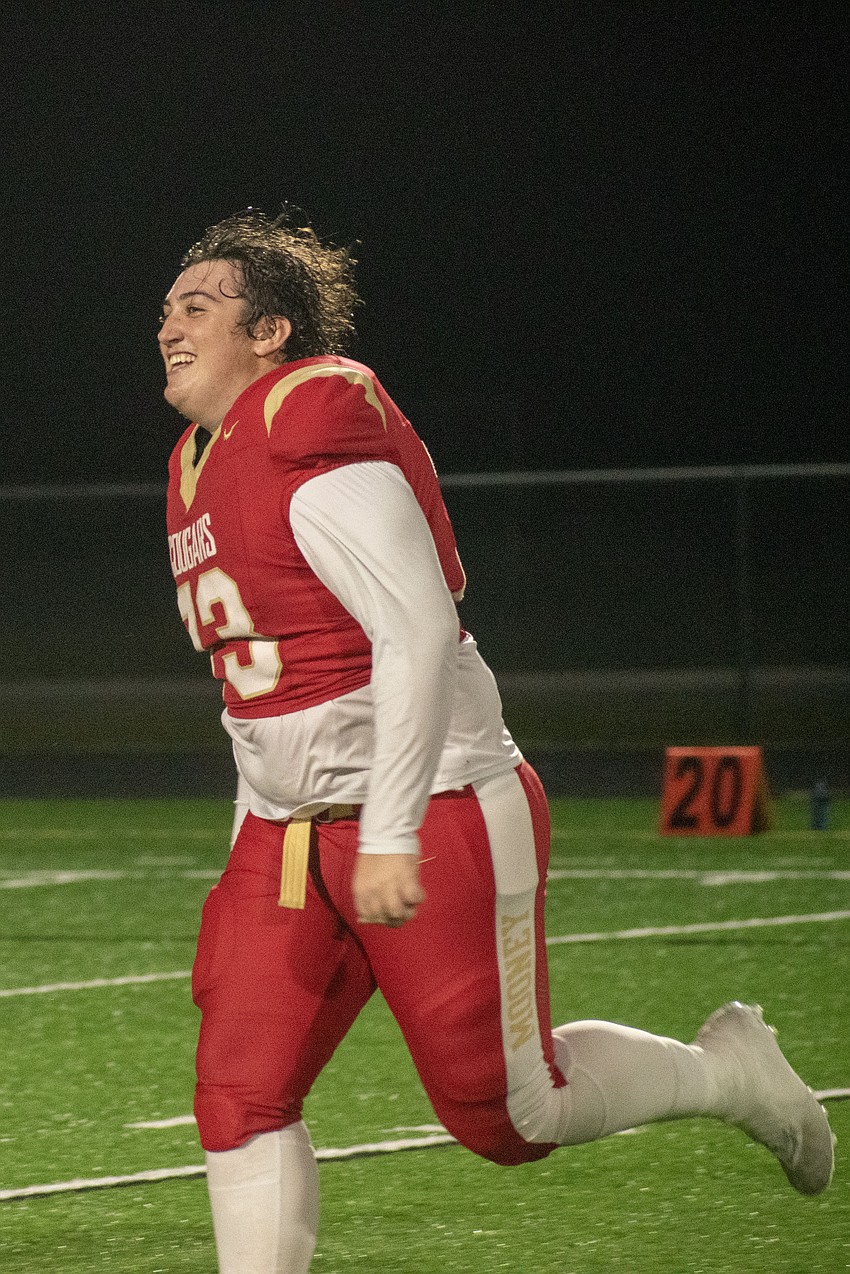 Mooney senior offensive lineman Ryan Sugg runs to join his teammates in celebration after the team's state semifinal win over NFC.