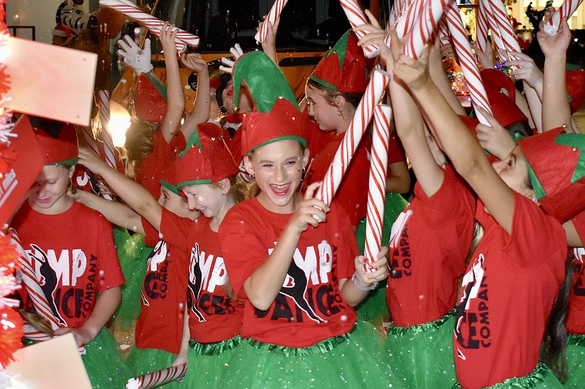 Students at Jump Dance company celebrate as their snow machine is activated, just before the start of the parade.