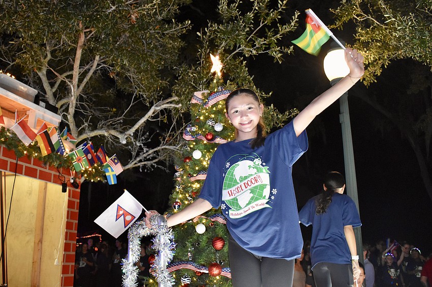 Sofia Carlson, 11, of Stage Door Studios, takes to the company's float as the parade begins.