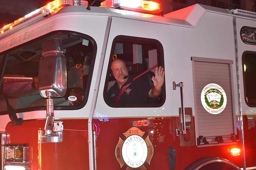 Firefighter / EMT Scott Hanlon waves to the crowds.