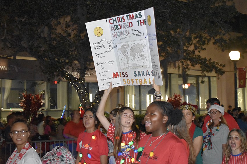 Members of Miss Sarasota Softball celebrate the parade's theme of Christmas around the world.