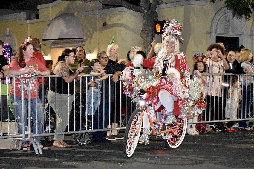 Ellie Porter greets the crowd as she rides past.