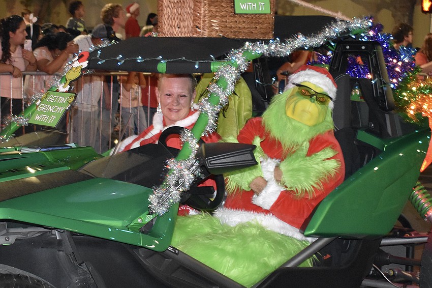 Denise and Bill Hanna ride as Cindy Lou Who and the Grinch, with Dark Side Comics.