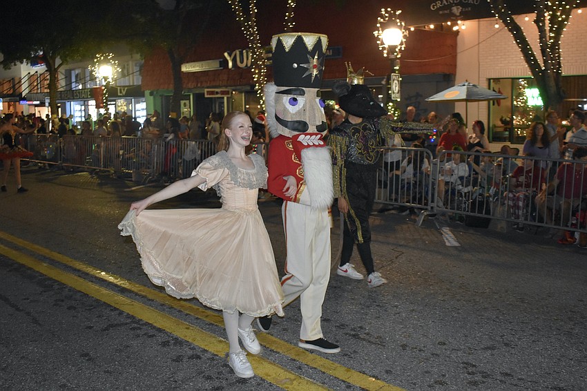 Macie Miersch, Gianni Salazar, and Noah Rodenberger walk the parade as Clara, the Nutcracker, and the Mouse King.
