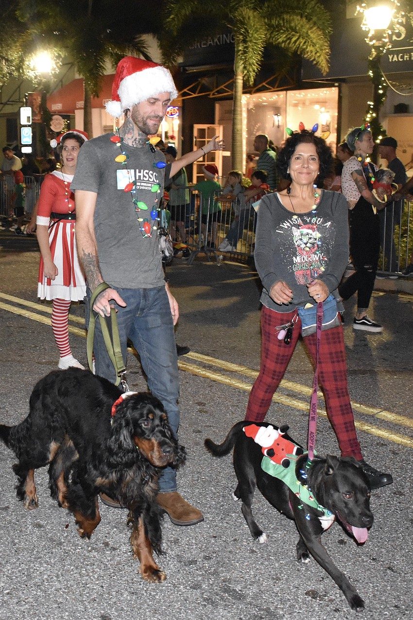 Jonathan Tedrick walks Winston and Jackie Hiatt walks Cozumel, with the Humane Society of Sarasota County.