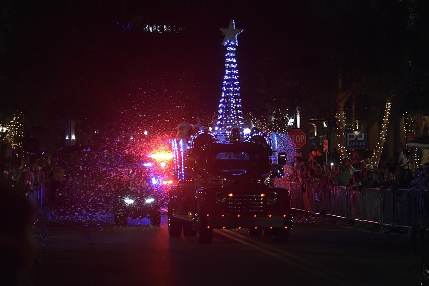 The fire truck carrying Santa Claus approaches.