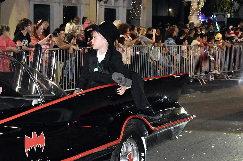 Easton Nock, 8, rides the Batmobile as The Penguin, with Dark Side Comics.