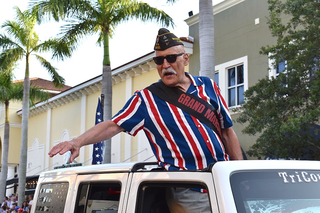 Gill Ruderman, of Braden River VFW Post 12055, enjoys his ride as the 2023 Tribute to Heroes Parade grand marshal.