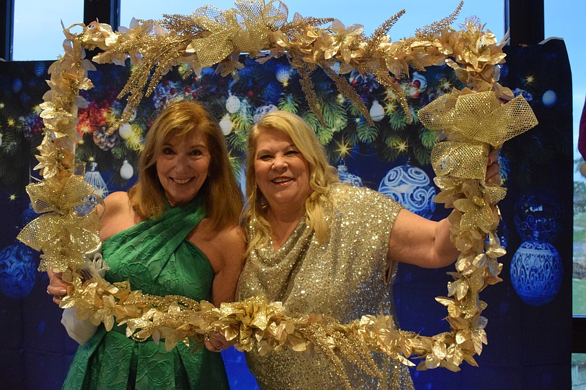 River Club's Cheryl Sabins has helped River Club social chair Maureen Rosin decorate for the community's first Jingle Ball.