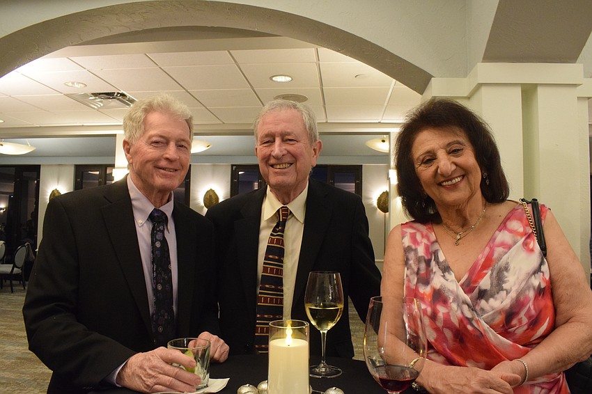 The Jingle Ball is a time for River Club residents like Robert Newport and Tom and Sal Ballantyne to make new friends while reconnecting with old friends.