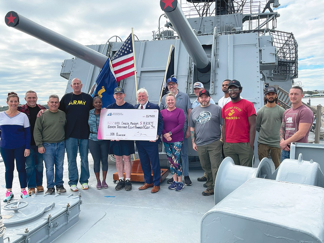 Volunteers from the Jacksonville Bar Association Veterans and Military Affairs Committee presented a donation to the USS Orleck Museum on Nov. 4 after a day of service aboard the warship docked along the Downtown Northbank.