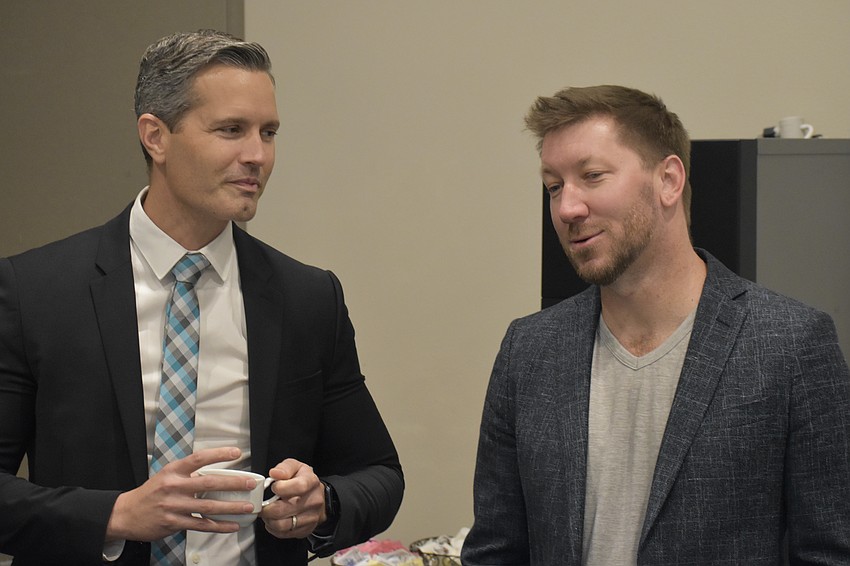 Terry Connor talks with David Crawford, a representative of the REALTOR Association of Sarasota and Manatee, which was a partner of the event.