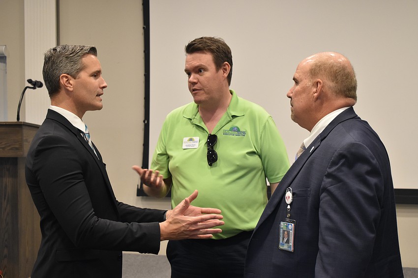 Terry Connor talks with Jonathan Evans and  Craig Maniglia.