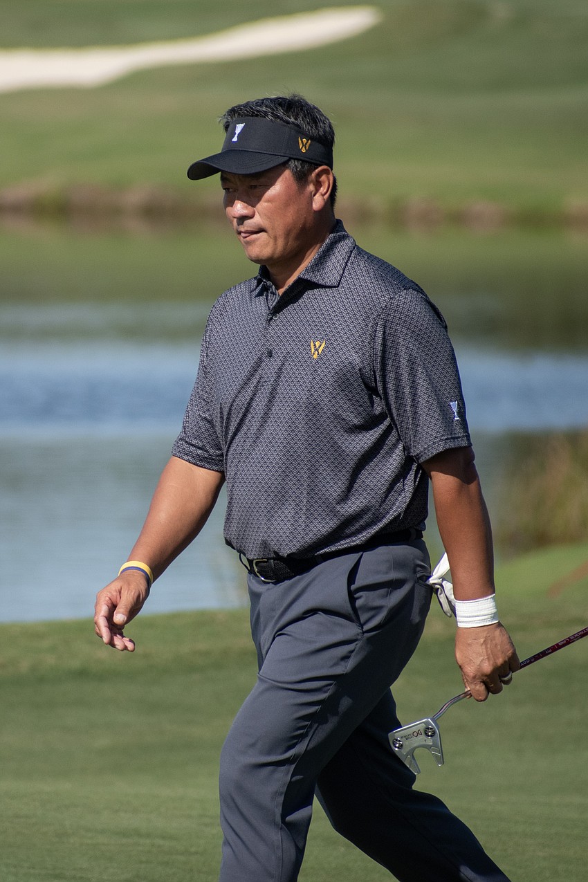 Team International's K.J. Choi walks onto the green on the No. 9 hole at the Concession Golf Club during the Six Ball morning session of the World Champions Cup. Choi and teammate Ernie Els would par the hole.