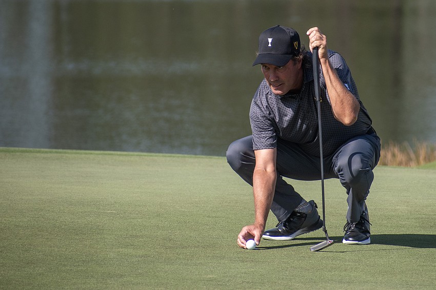 Team International's Stephen Ames lines up a putt, with a look of determination, on the No. 9 hole at The Concession Golf Club during the Six Ball session on day one of the World Champions Cup.