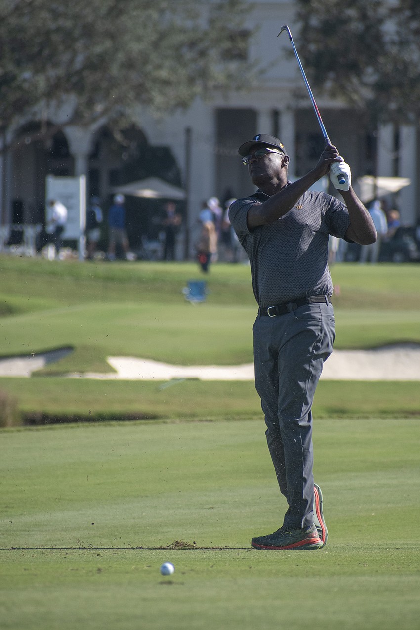 Team International's Vijay Singh hits an approach shot on the No. 1 hole at The Concession Golf Club during the Scotch Sixsome round on day one of the World Champions Cup.