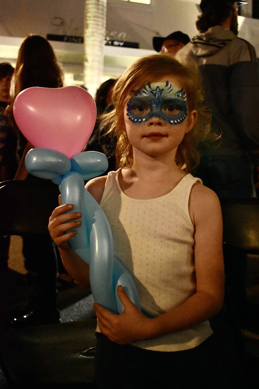 Emilia Barnhart stops dancing to show off her balloon.