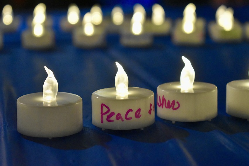 Guests write on candles for Israel. The candles are laid out as a Star of David.