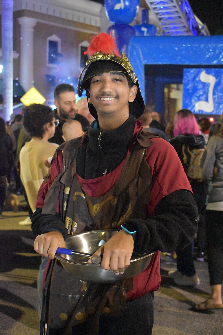 Borat Sagdiyev hands out dreidels dressed as a Maccabee.