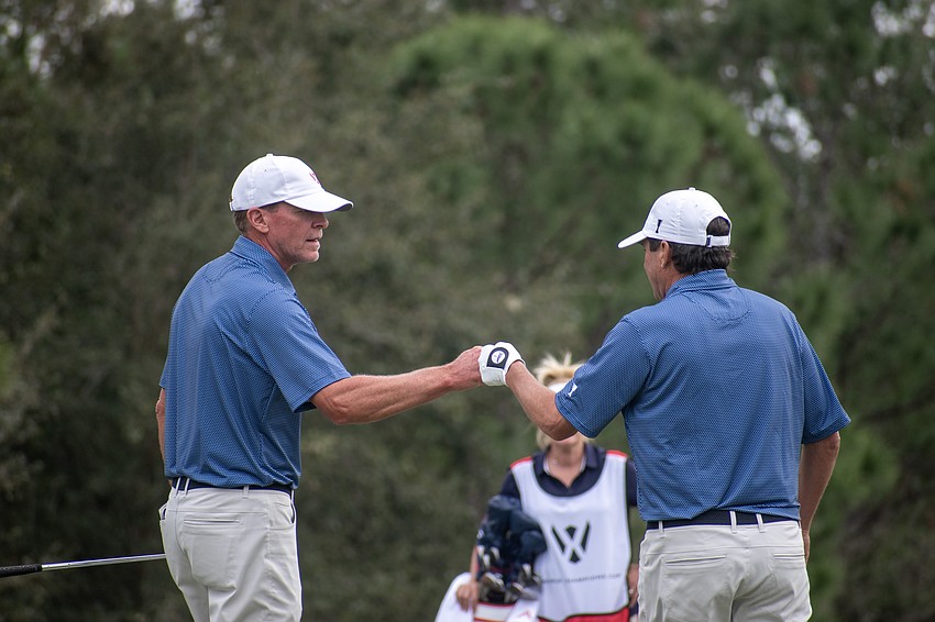 Team USA's Steve Stricker and Billy Andrade bump fists after saving par on the No. 4 hole at The Concession Golf Club on day two of the World Champions Cup. The pairing would earn 11 points for Team USA during the day's Scotch Sixsome session.