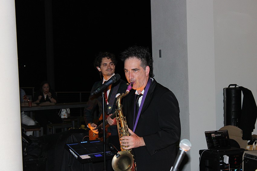 Ronnie Dee blasts a tune on the sax for the Bay Kings Band during the World Champions Cup block party on Friday night at Waterside Place in Lakewood Ranch.