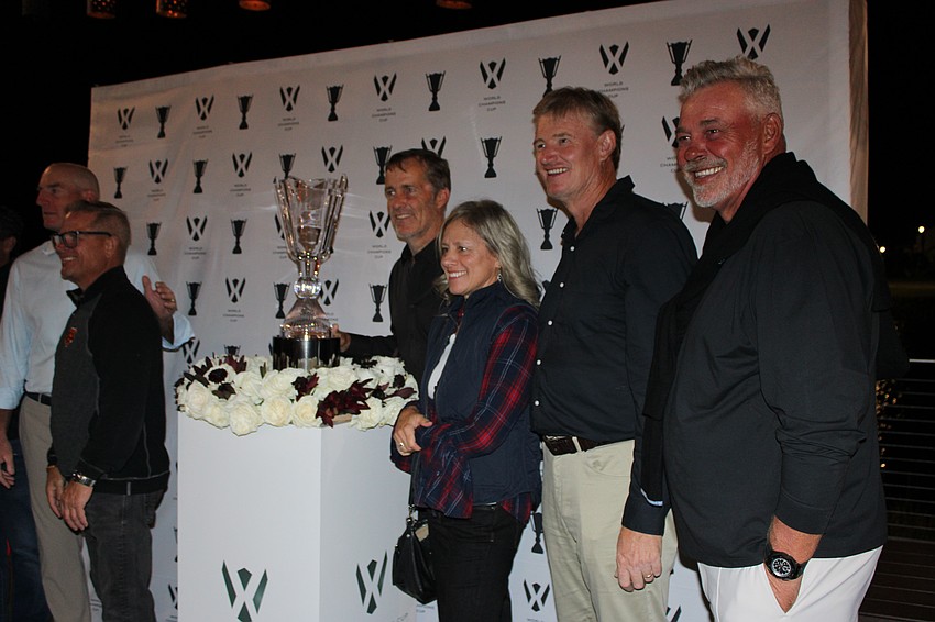 Jim Furyk, Lakewood Ranch's Kevin Stoll, Stuart Appleby, Lakewood Ranch's Sue Gregus, Ernie Els and Darren Clarke get together for a photo with the World Champions Cup trophy.