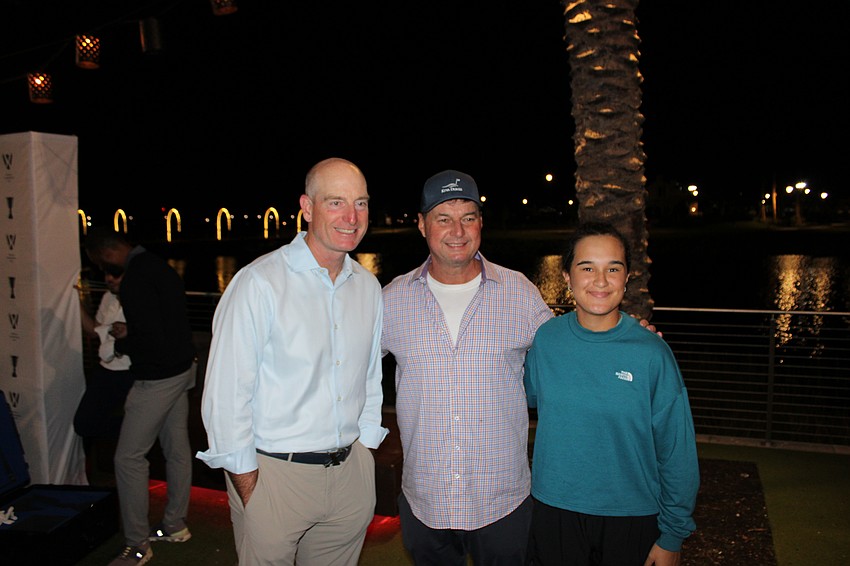 Team USA Captain Jim Furyk poses with Gene Storm and Emily Storm at the World Champions Cup block party at Waterside Place. Emily Storm is on the golf team at Lakewood Ranch High.