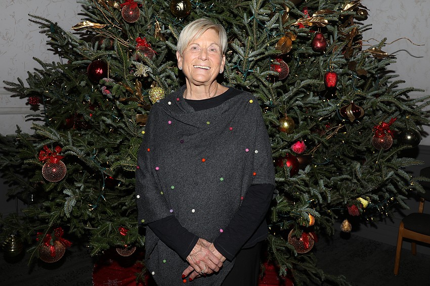 Marlene Meyer strikes a pose in front of the fabulous Michael's On East Christmas tree.