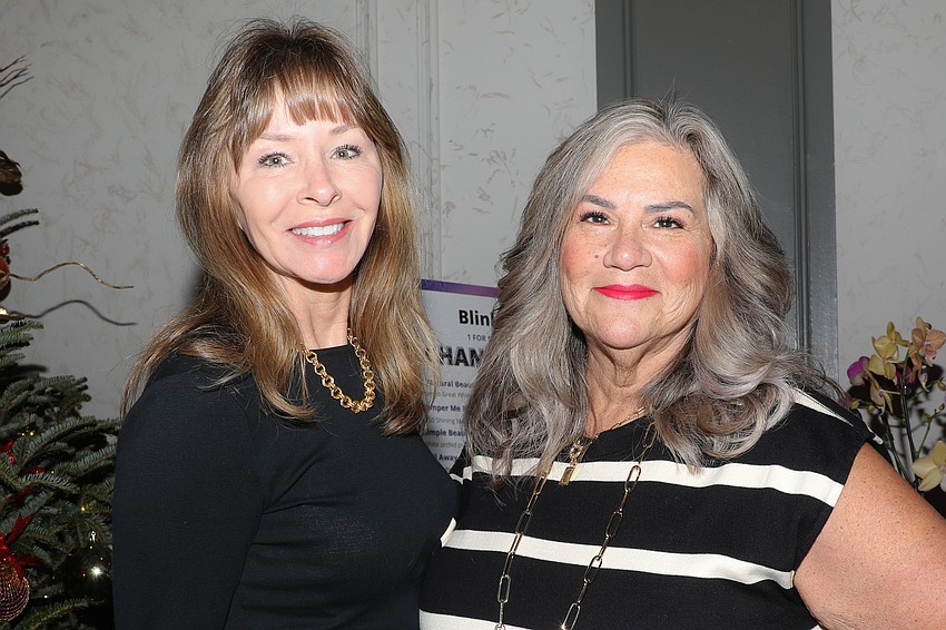 Kelly Dean and Dawn Anton peruse the silent auction table filled with beautiful gift baskets the SPARCC Auxiliary put together.