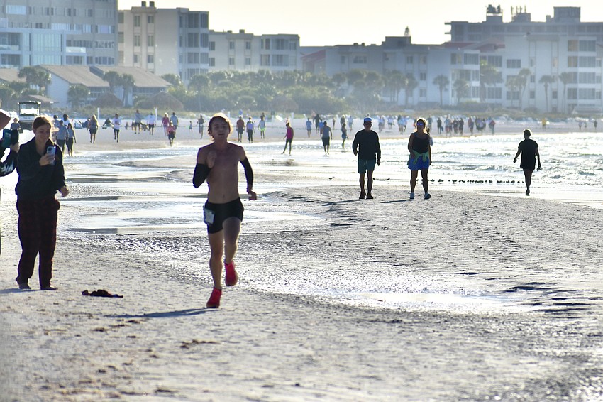 Declan Fiorucci, first-place overall winner in the 5K, makes his way to the finish line.
