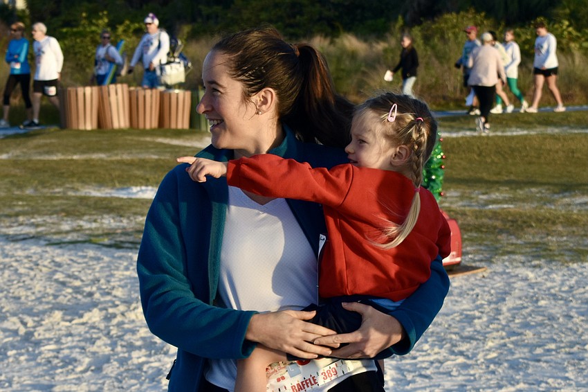 Claire Durand introduces Vanessa Wood, 3, to the event.