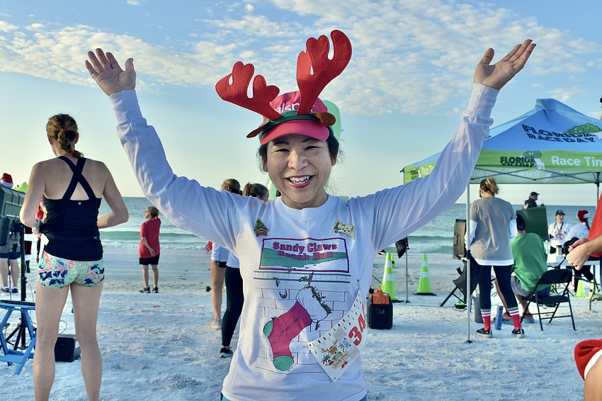 Lee-En Chung wears a shirt showing when she first ran in the Sandy Claws Beach Run, 1992.