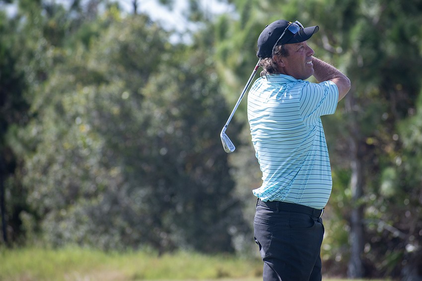 Team International's Stephen Ames watches his second shot on the No. 4 hole at The Concession Golf Club on the final day of the World Champions Cup. Ames would par the hole to earn one point.