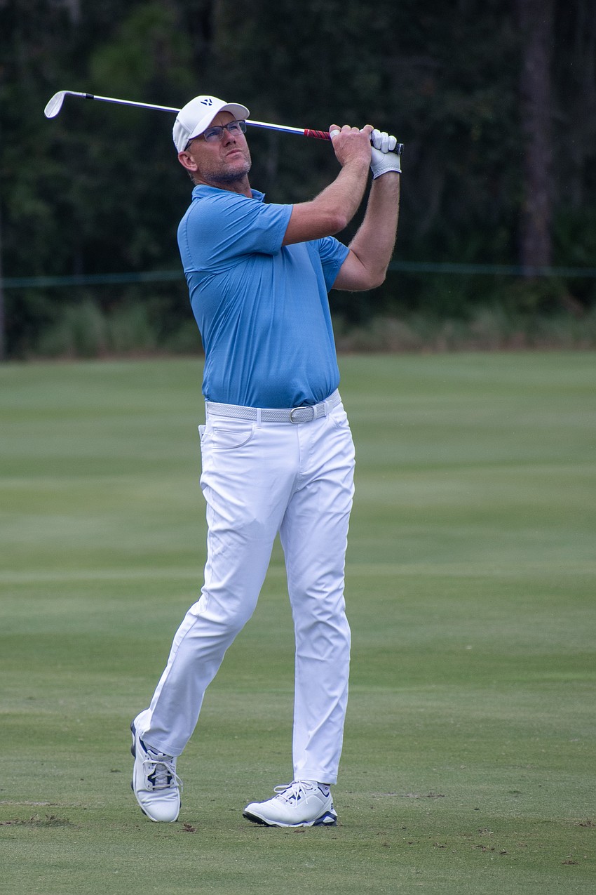 Team Europe's Robert Karlsson hits his second shot on the No. 7 hole at The Concession Golf Club on the final day of the World Champions Cup. Karlsson would par the hole and earn one point.