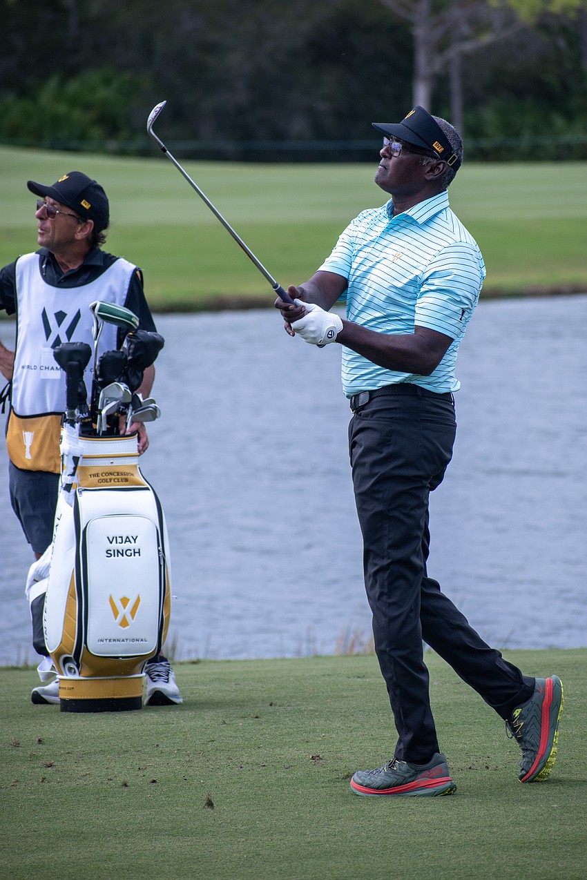 Team International's Vijay Singh hits his third shot on the No. 9 hole at The Concession Golf Club on the final day of the World Champions Cup. Singh would bogey the hole to earn zero points.
