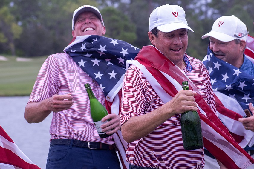 Steve Stricker, Billy Andrade and Andrade's caddy, Mark Zyons, celebrate with champagne following Team USA's win at the first-ever World Champions Cup, held at The Concession Golf Club.
