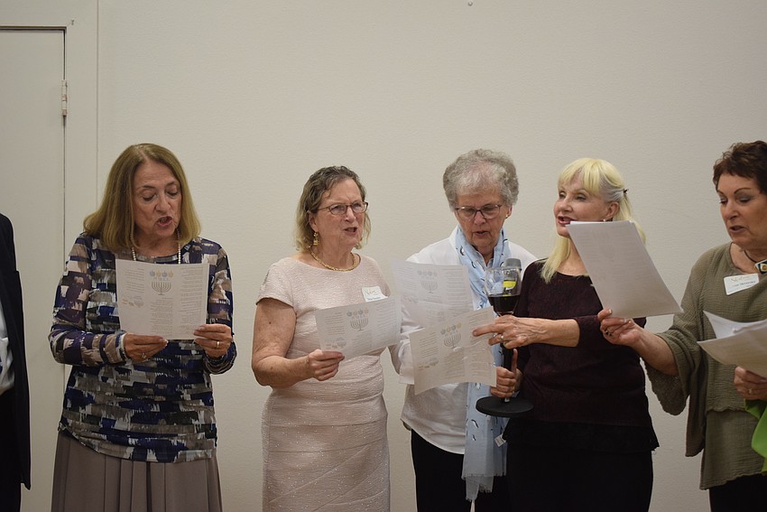 Rabbi Stephen Sniderman and Beth Israel Women sing traditional Jewish songs at their Hanukkah feast.