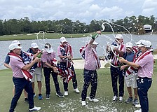 Team USA pops bottles of champagne to celebrate winning the first-ever World Champions Cup, held at The Concession Golf Club.