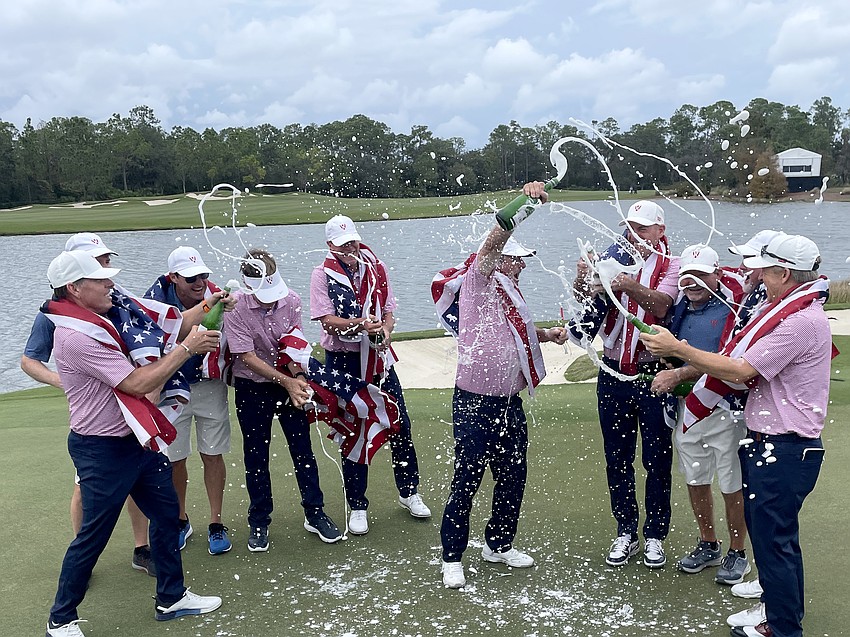 Team USA pops bottles of champagne to celebrate winning the first-ever World Champions Cup, held at The Concession Golf Club.