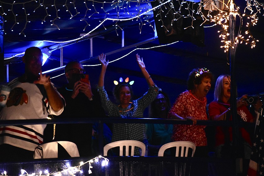 Guests on LeBarge Tropical Cruises throw a party along the parade route.