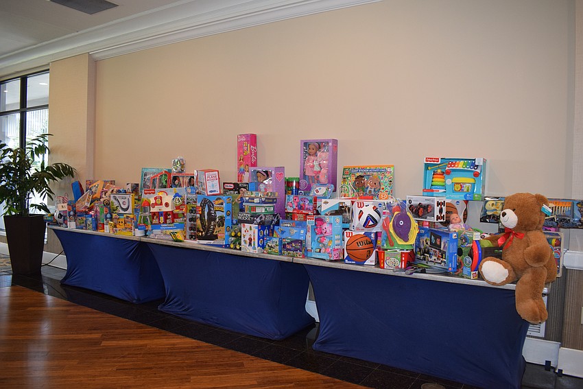 The Women's Golf Association of Longboat Key collects donations for Toys For Tots at their annual Frosty Frolic.