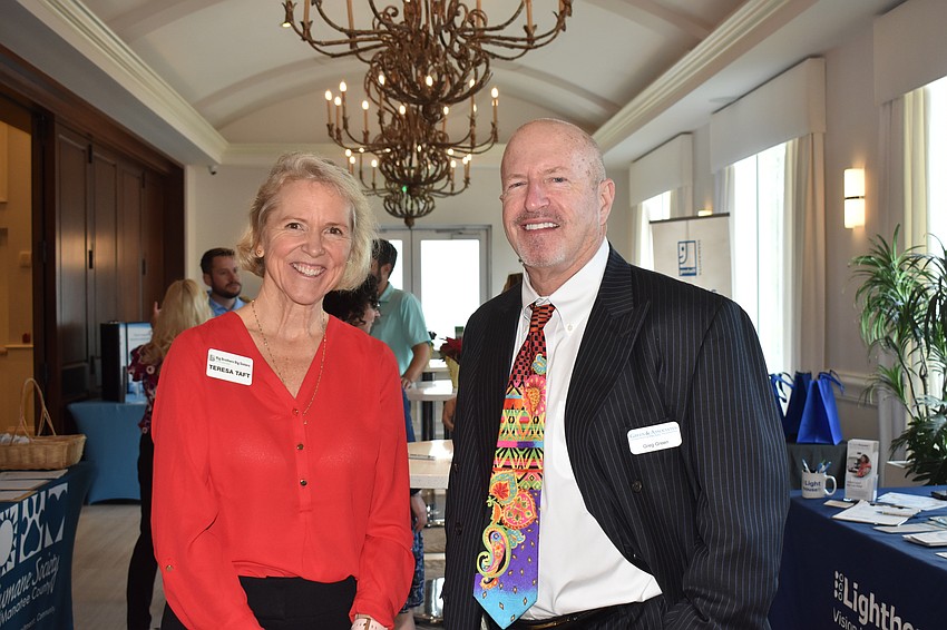 Teresa Taft, a recruiter for Big Brothers Big Sisters of the Sun Coast, talks with Greg Green of Green & Associates CPAs before the presentation.