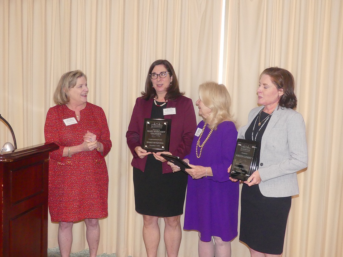 From left, U.S. District Judge Marcia Morales Howard presented the 2023 Spirit of Giving Award for civil law practitioner to attorneys Mary Margaret Giannini, Suzanne Judas and Kirsten Clement.