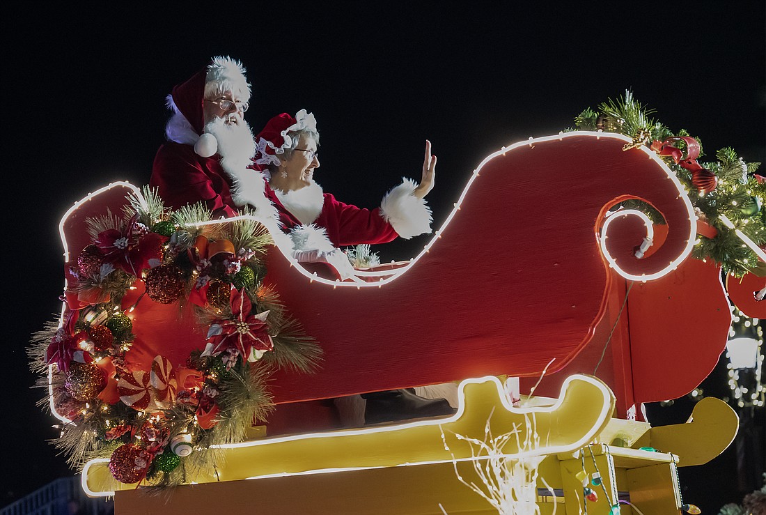 Santa and Mrs. Claus arrive on the award winning Abaco Windows float at the 32nd annual HOme for the HOlidays Nighttime Parade. Photo by Michele Meyers