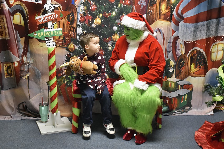 Mason Rivera, 7, meets The Grinch (Debbie Maxa).