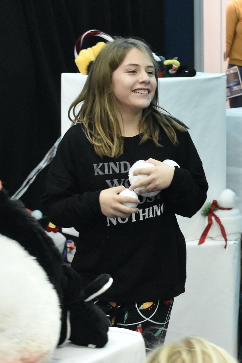 Mylah Cole, 9, prepares to toss multiple snowballs.