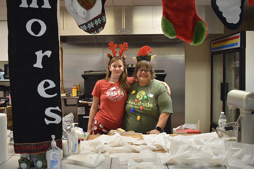 Mia Stewart, 11 and Leslei Wessel stand behind some of the s'mores they baked.