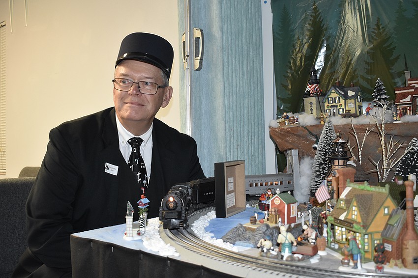 Donald Kaplan conducts the two model trains.