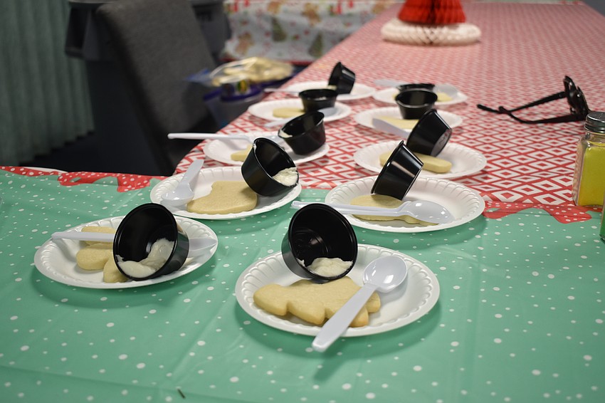 Cookies and icing are set out for taking.